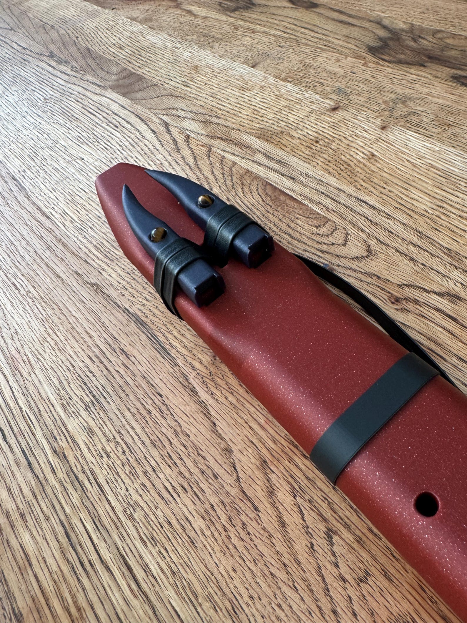 Detail of the twin drone holes and leather ties