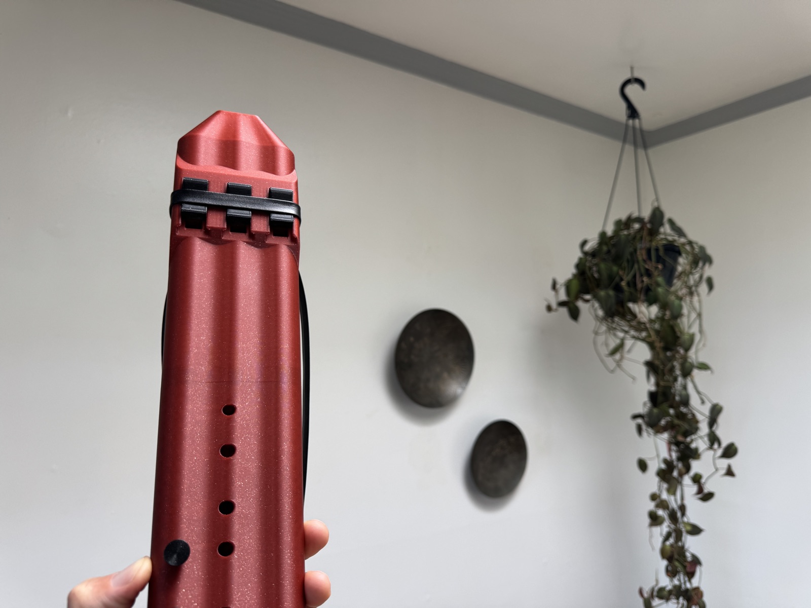 Triple drone flute held, showing the finger holes