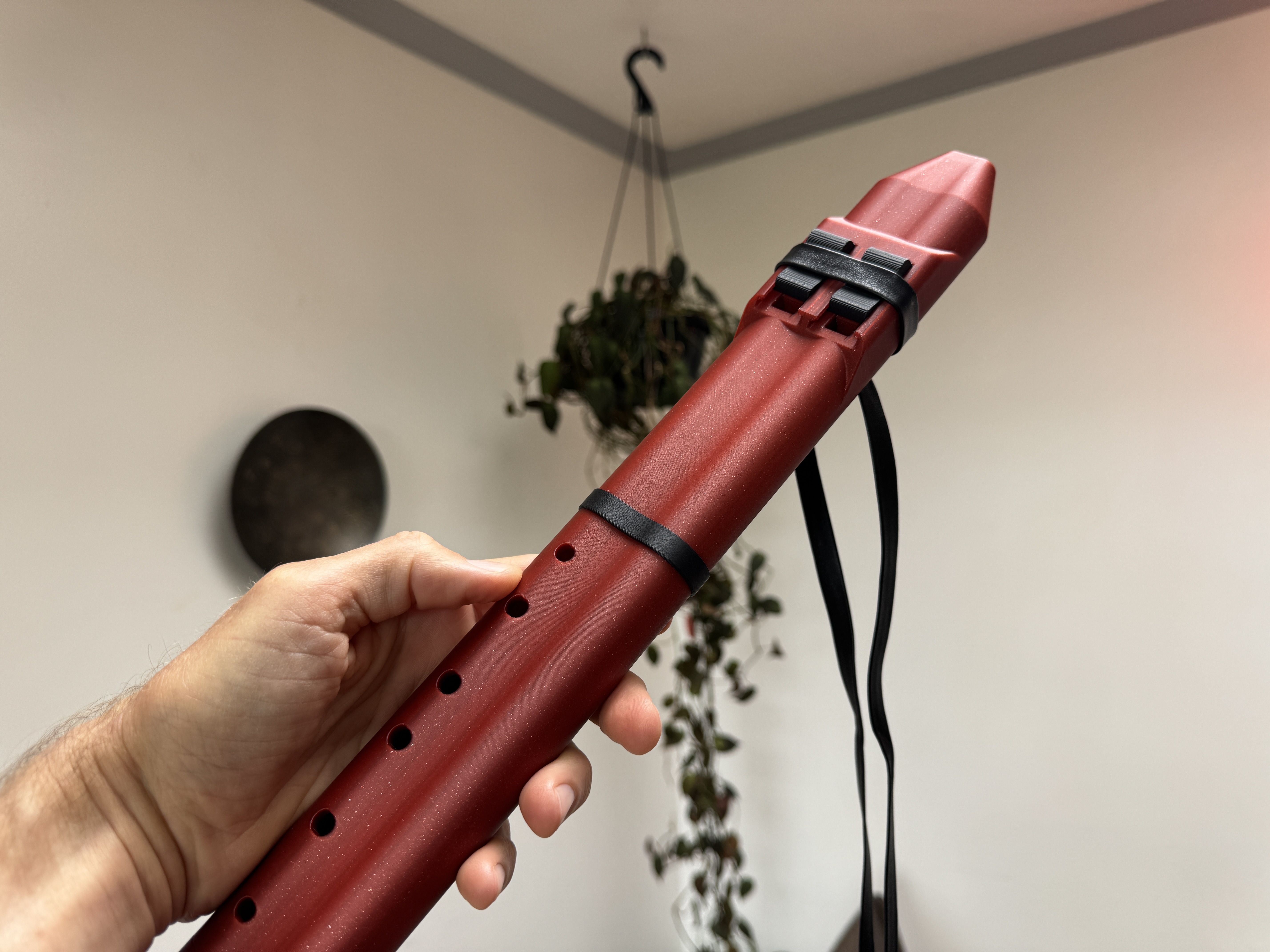 Drone Flute A held in hand showing scale and finger holes